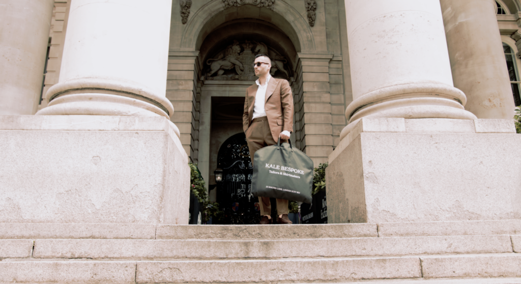 Man in bespoke suit stands outside The Exchange in the City of London