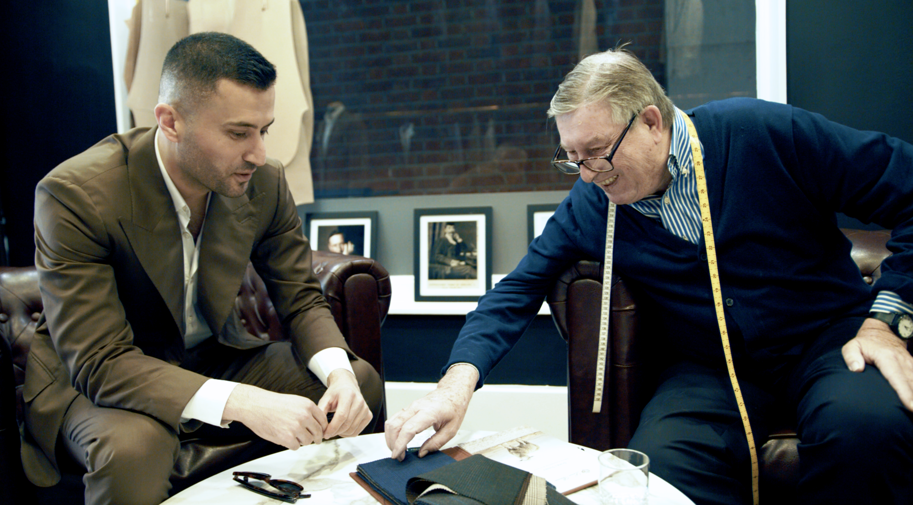 Tailors Choosing Cloth in City of London Tailoring Shop