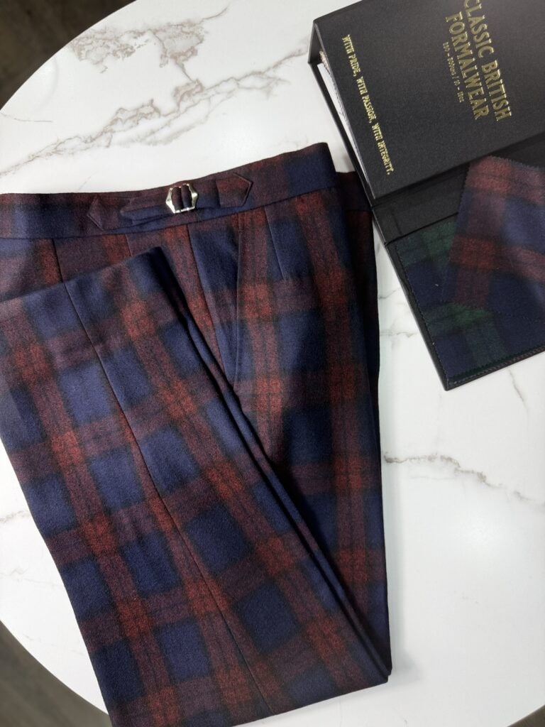 Bespoke blue check tartan trousers folded on the table