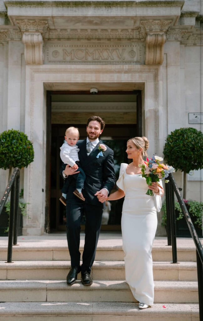 bride and groom on wedding day with child