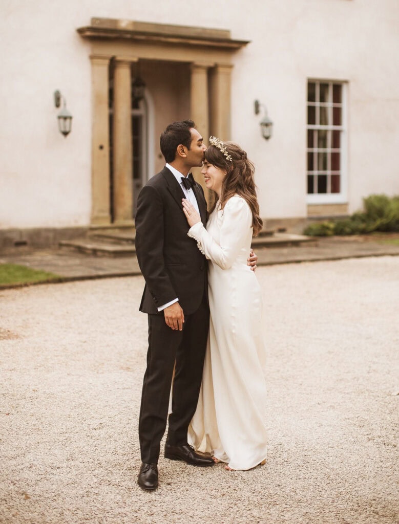 georgian house bride in wedding dress and groom in black tuxedo