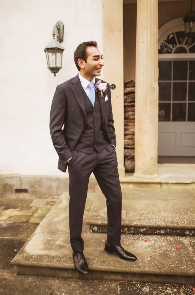 groom in blue bespoke three piece wedding suit