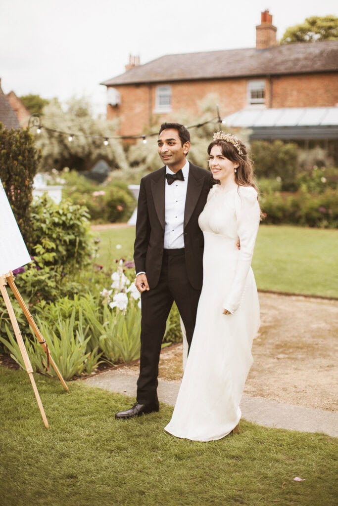 bride and groom on lawn on wedding day black tie