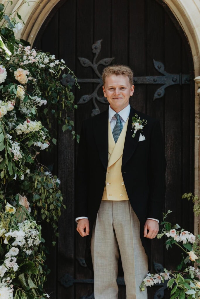 groom in bespoke morning suit with yellow waistcoat