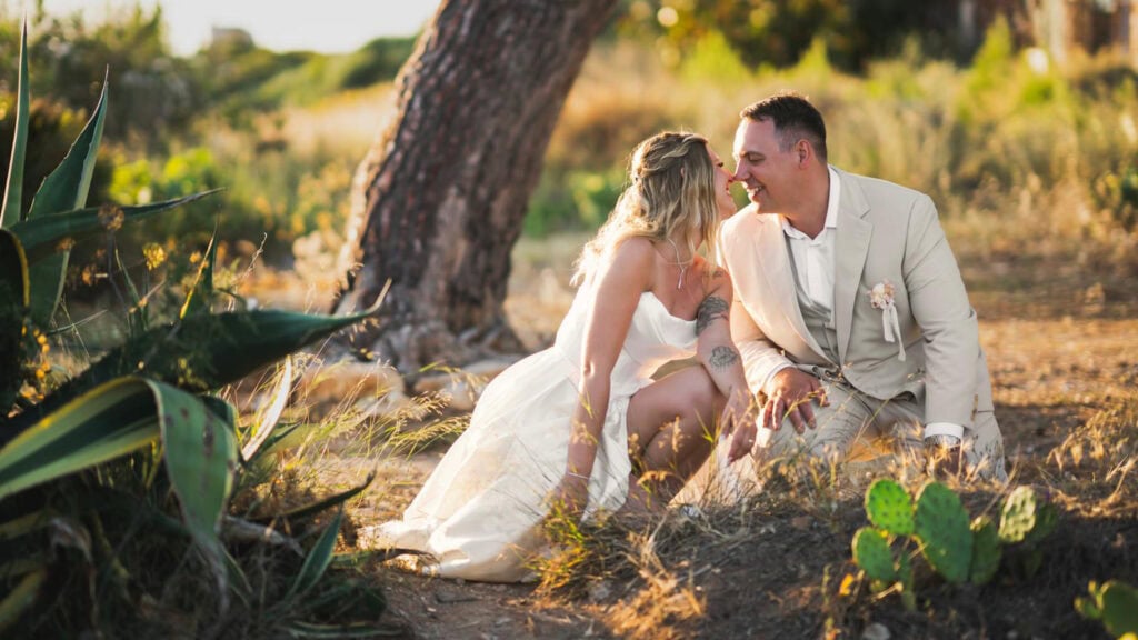 summer wedding couple with groom in light beige wedding suit